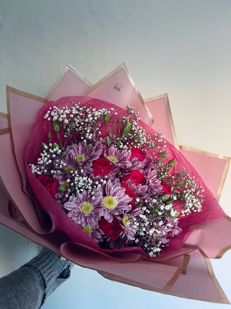 Purple chrysanthemum and red rose bouquet in pink wrap by Kalea Arrangements