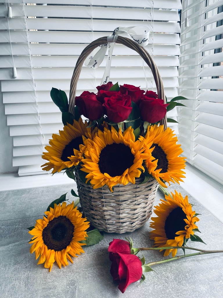Sunflower and red rose basket arrangement by Kalea Arrangements