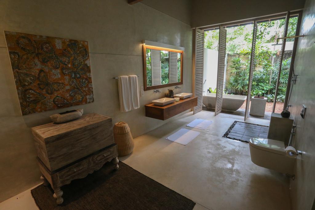 Indoor-Outdoor Bathroom — Vanity & Open Garden Shutters