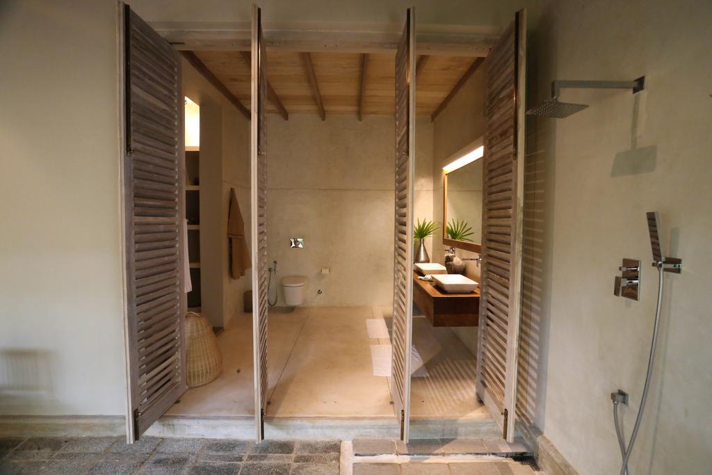 Bathroom Entry — Open Louvered Shutters & Stone Threshold