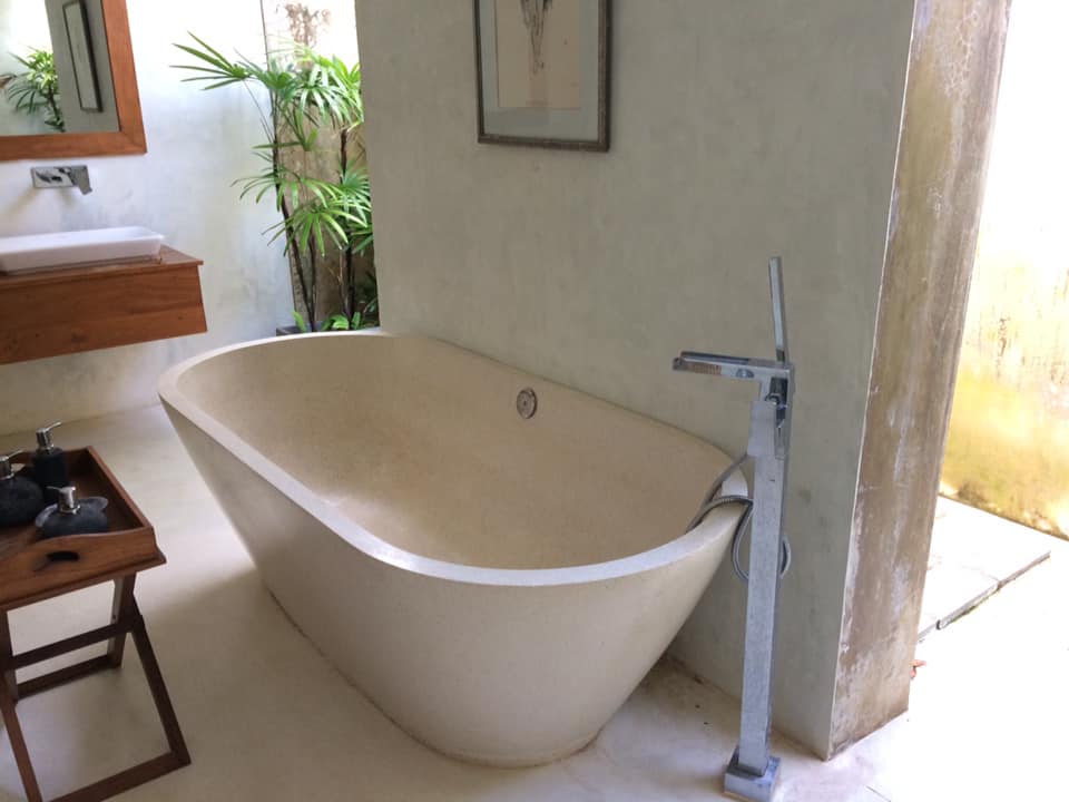 Bathtub Detail — Oval Stone Tub with Chrome Fittings
