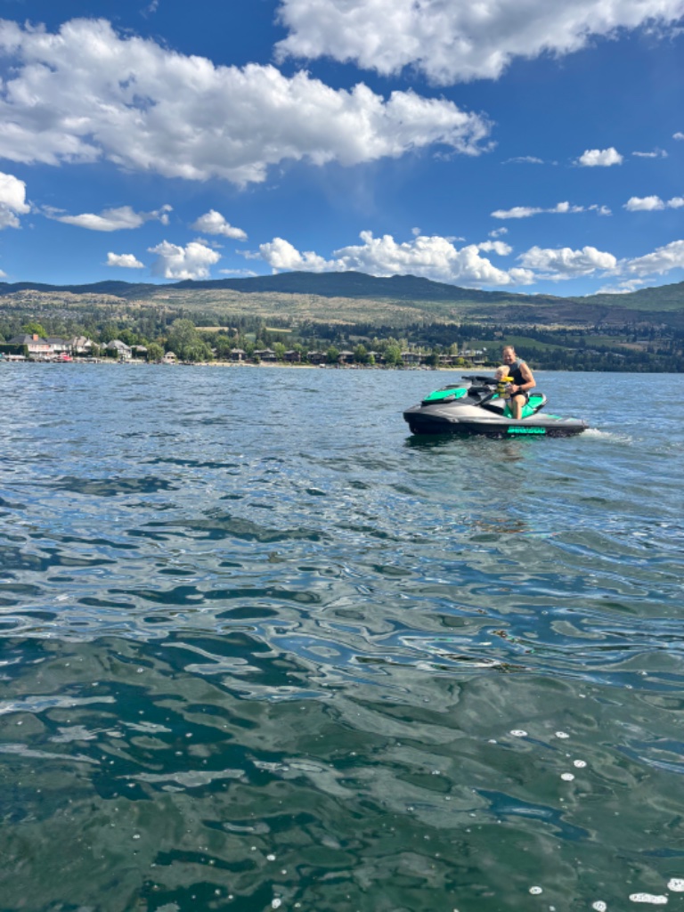 Father and child riding a Sea-Doo together on Okanagan Lake