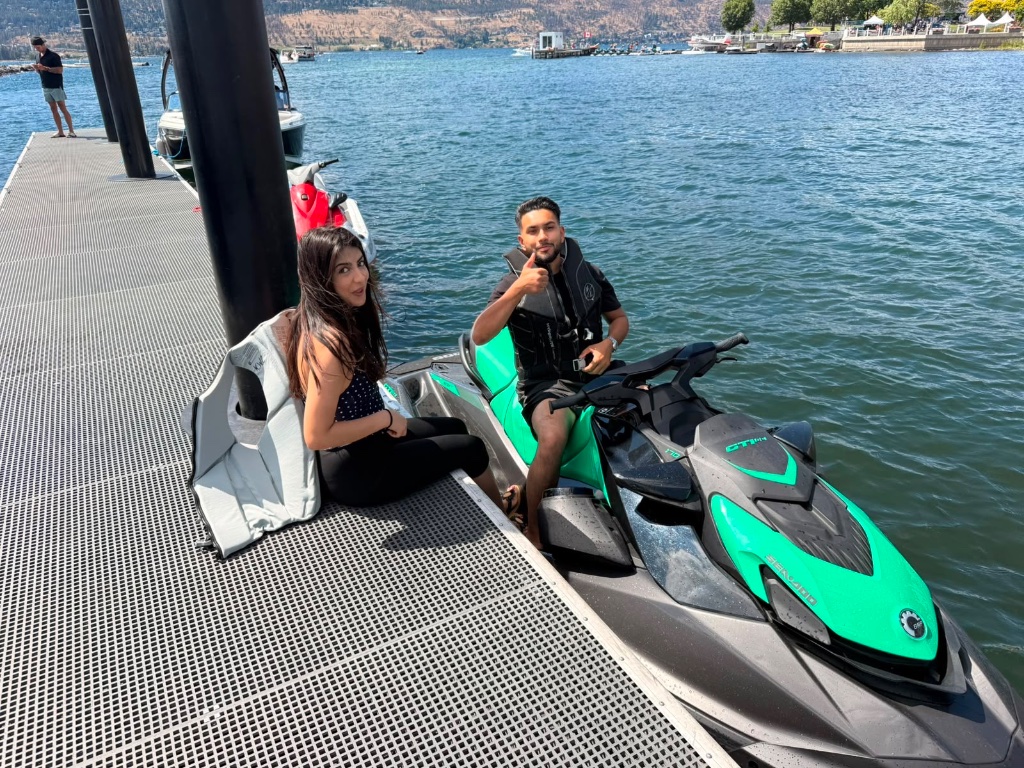 Two riders comfortably seated on the wide hull of a Sea-Doo GTI SE 170