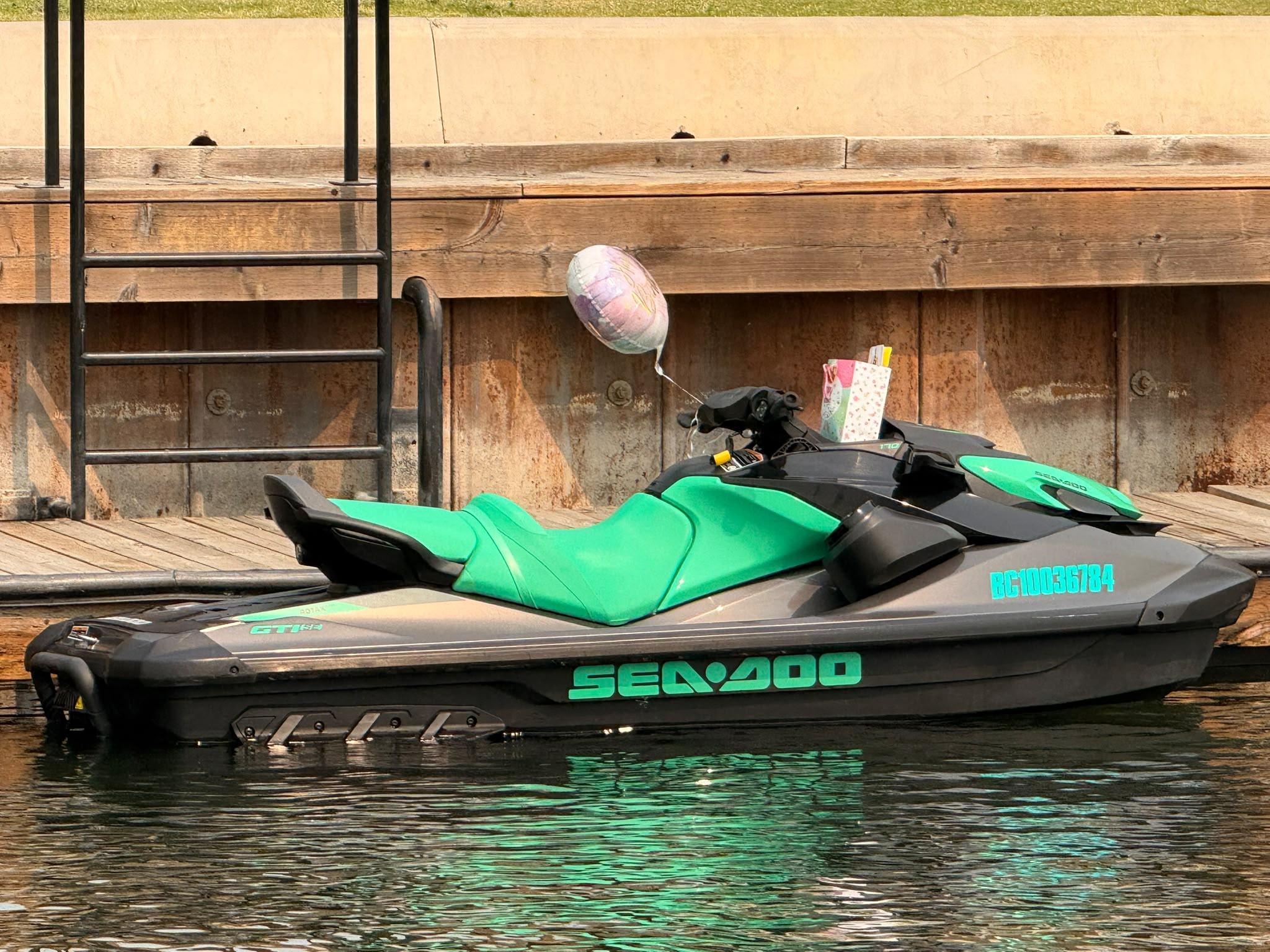 Sea-Doo and boat enjoying Okanagan Lake with mountains in the background