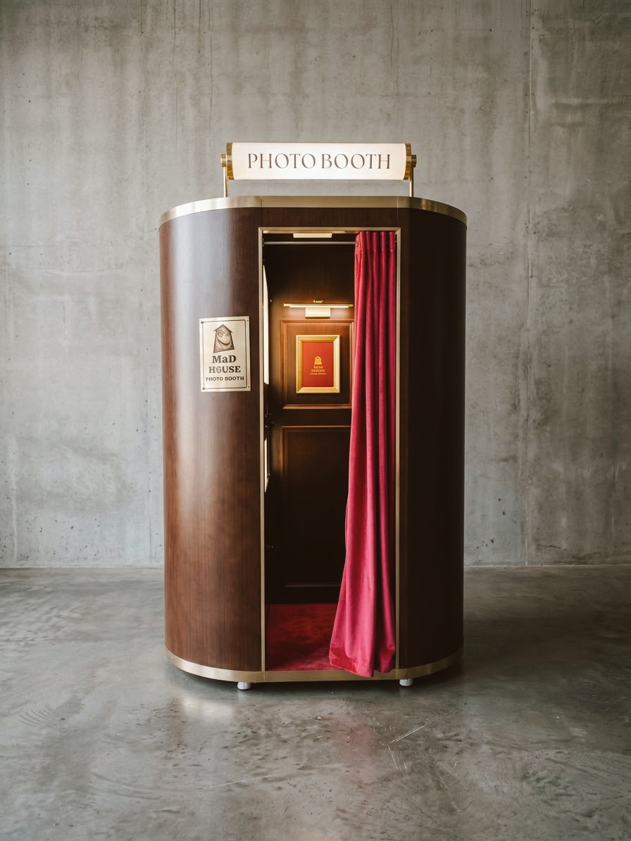 Custom walnut photobooth with illuminated marquee sign and magenta velvet curtain