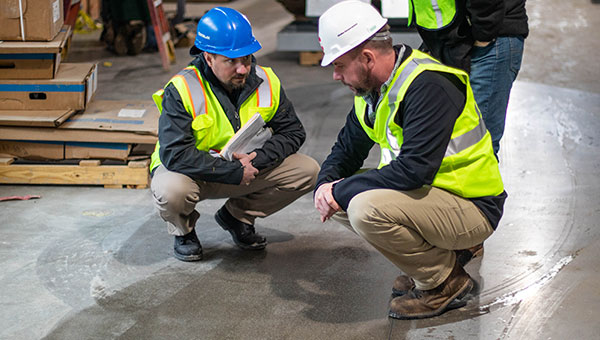 Contractor installing epoxy flooring in a commercial building