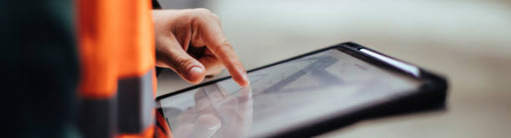 Construction worker using tablet on jobsite