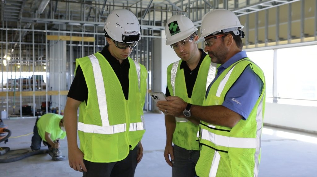 Contractors reviewing CLīMIT app on site