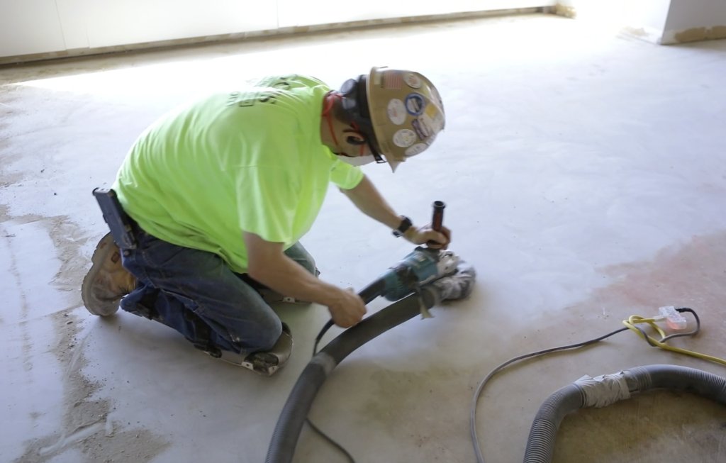 Contractor grinding concrete slab