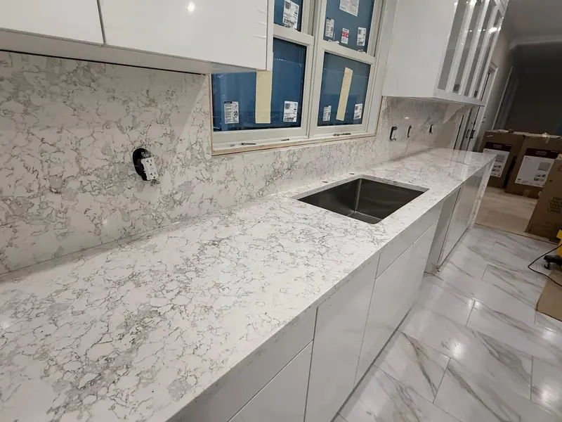 White marble-look quartz countertop with undermount stainless steel sink and full-height backsplash, Schenectady