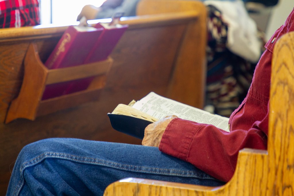 Church member reading the Bible in the pew