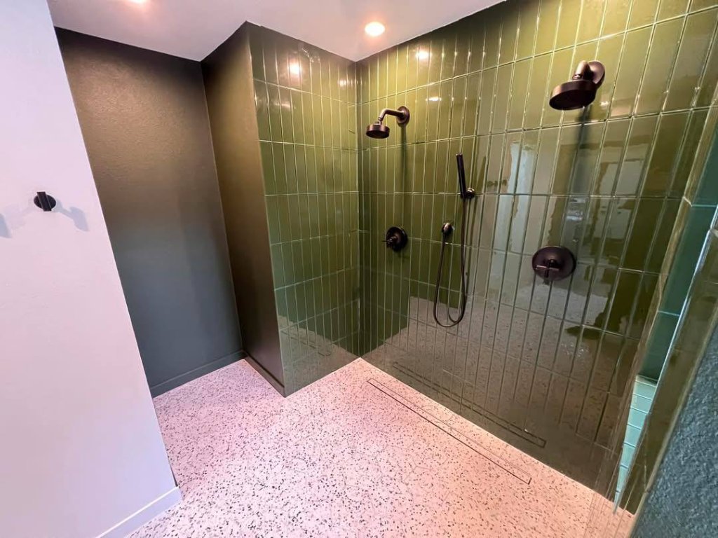 Full suite view — separate WC, terrazzo, green tile, console sink