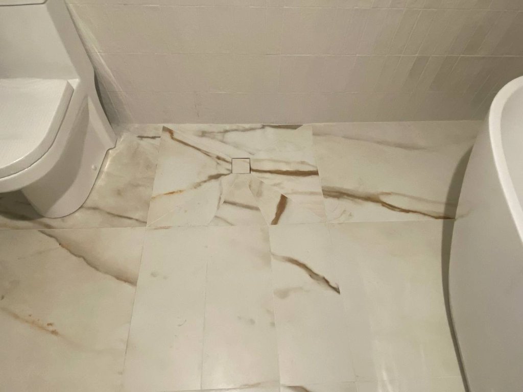 Curbless shower floor — Calacatta marble
