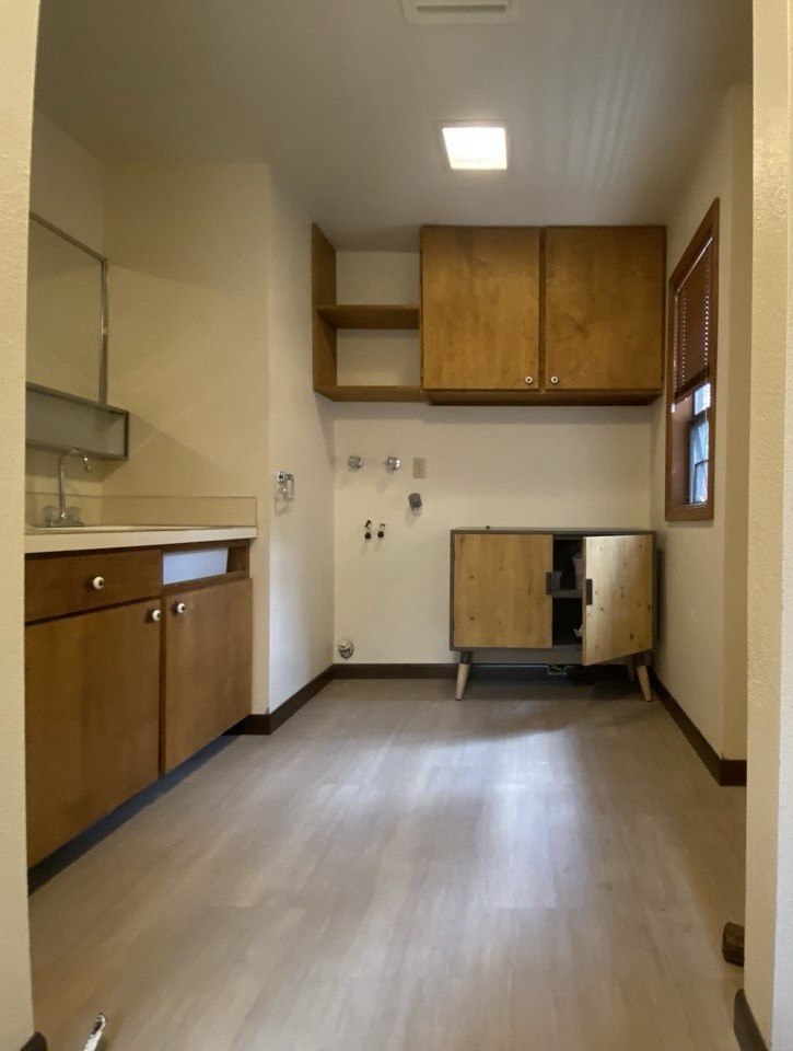 Before — straight-on view of laundry room being converted to shower