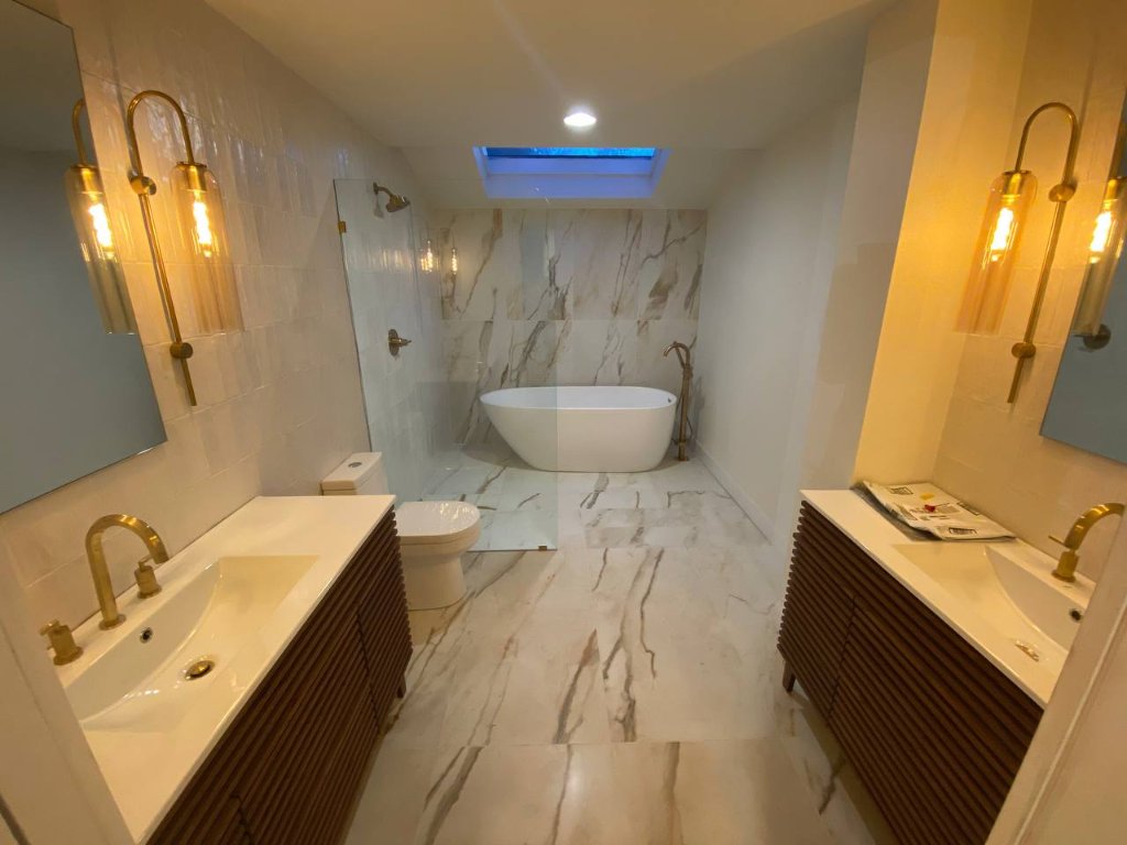Luxury master bathroom — Calacatta marble, freestanding soaker, brass fixtures — Bellevue, WA