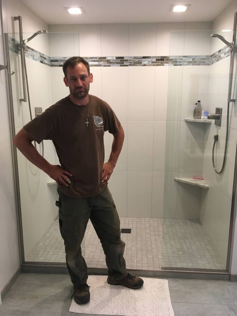 Gordon Montgomery — master craftsman — in front of completed his and hers shower