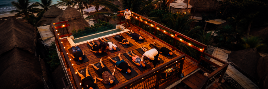 Tribu Halo group experience on a rooftop with warm lighting