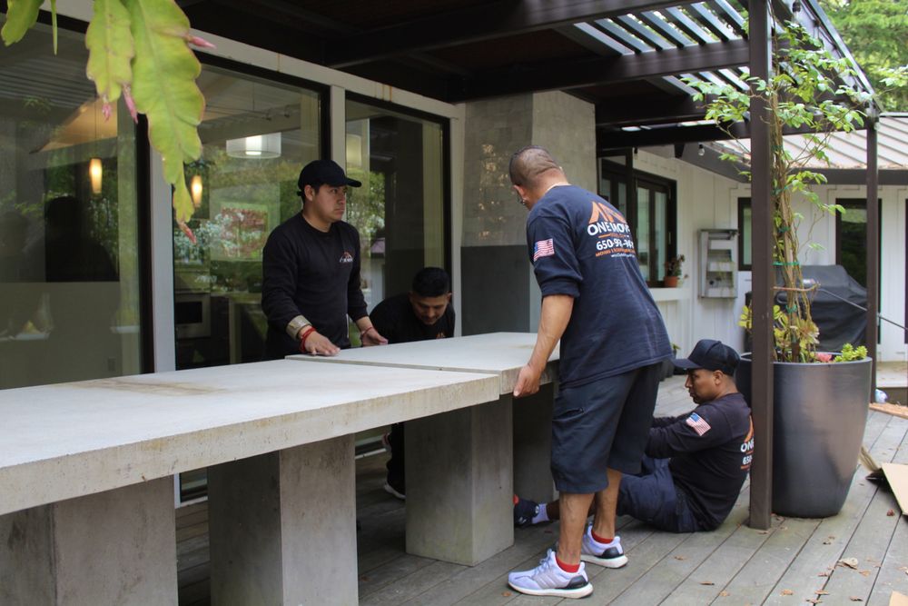 One Move Movers team moving concrete table
