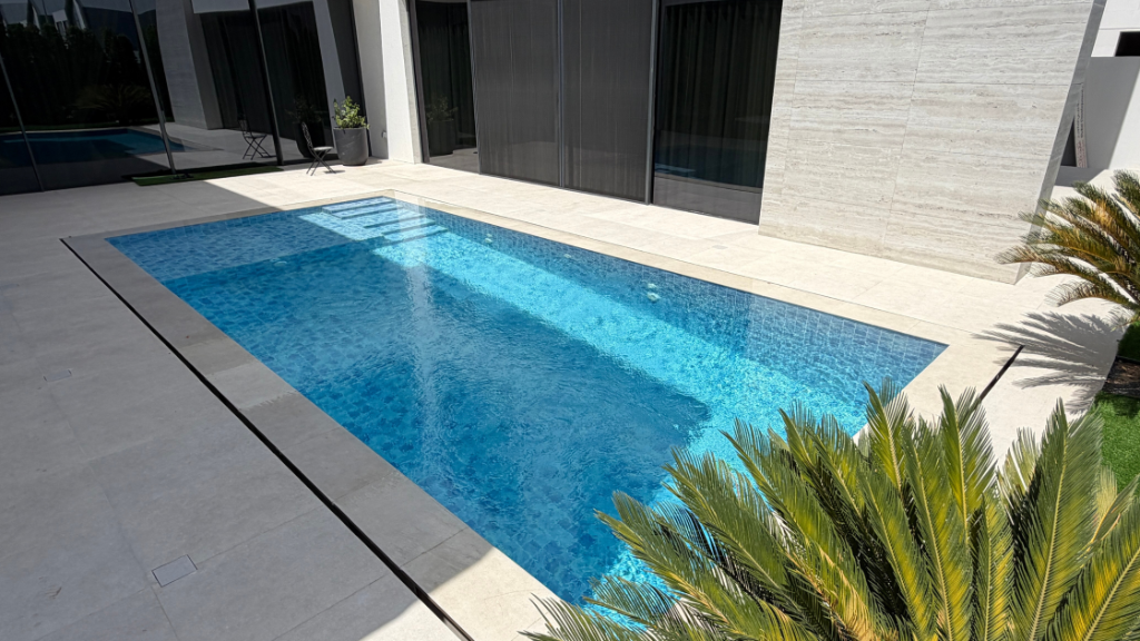 Clean, well-maintained residential swimming pool with clear blue water by Bluescape
