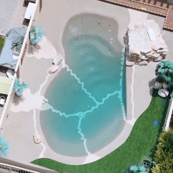 Aerial view of a beach entry fiberglass pool with lagoon-style design