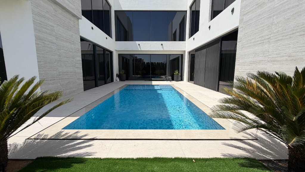 Crystal-clear blue swimming pool water in a modern residential villa