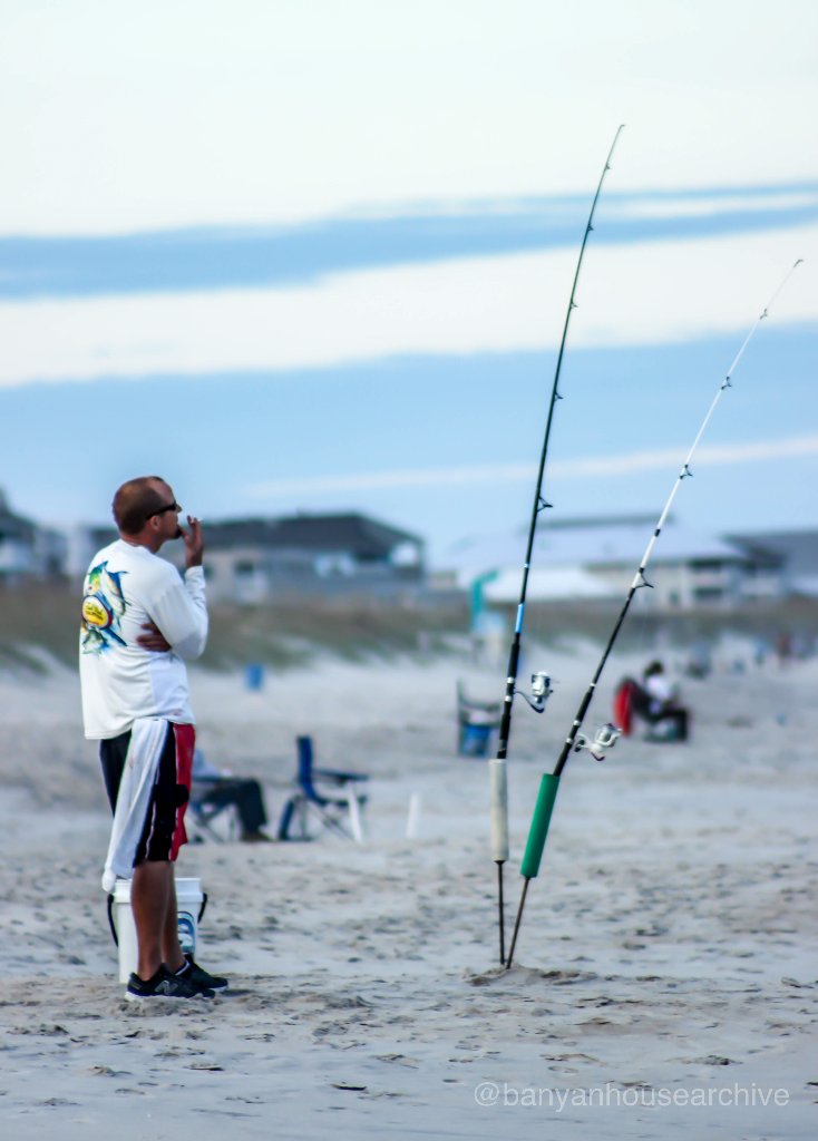 Fisherman with surf rods on the beach