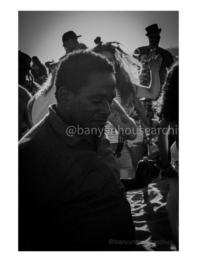 Man dancing in a crowd, black and white