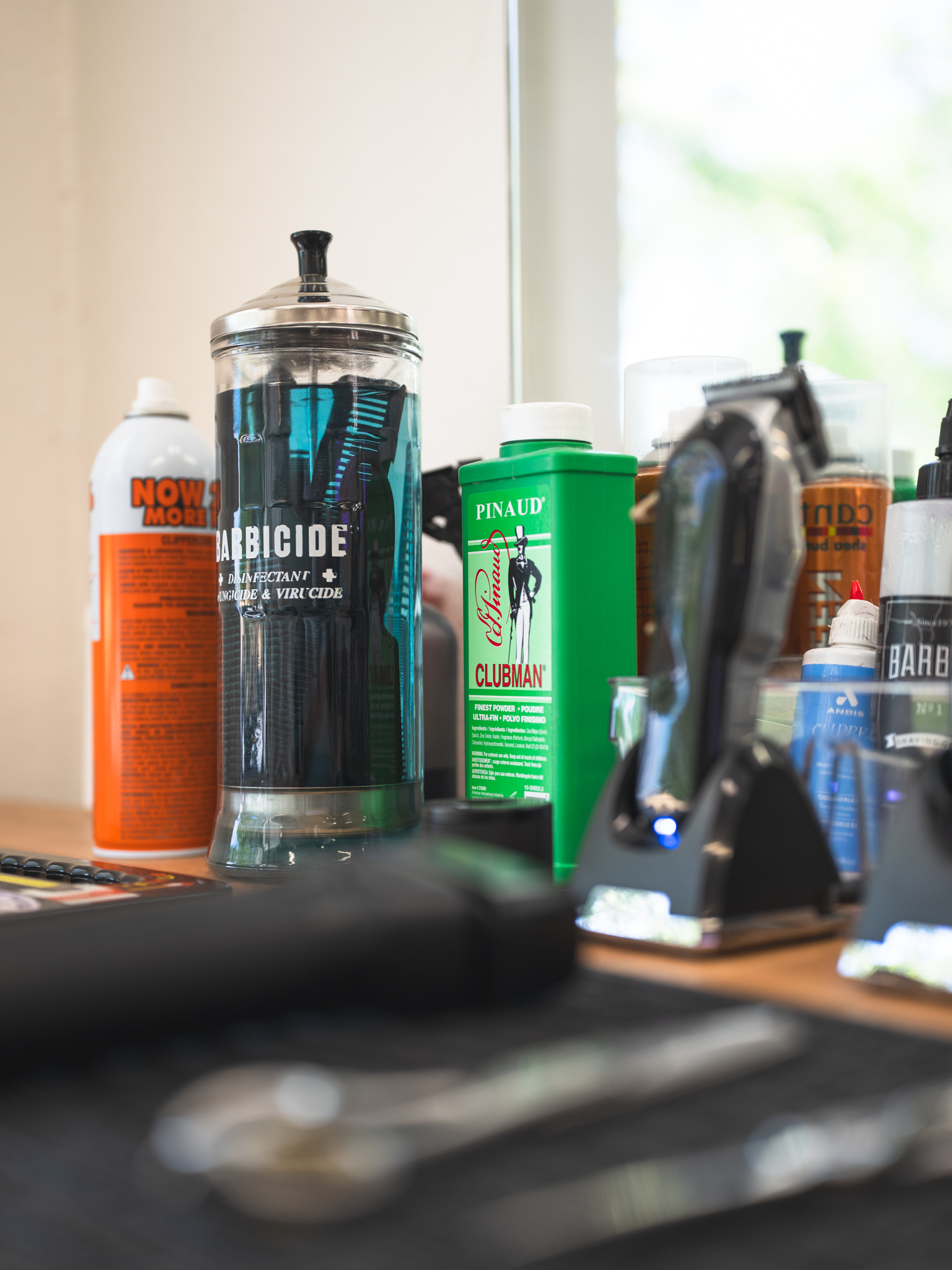 Professional barber tools — clippers and trimmers arranged on a wooden station