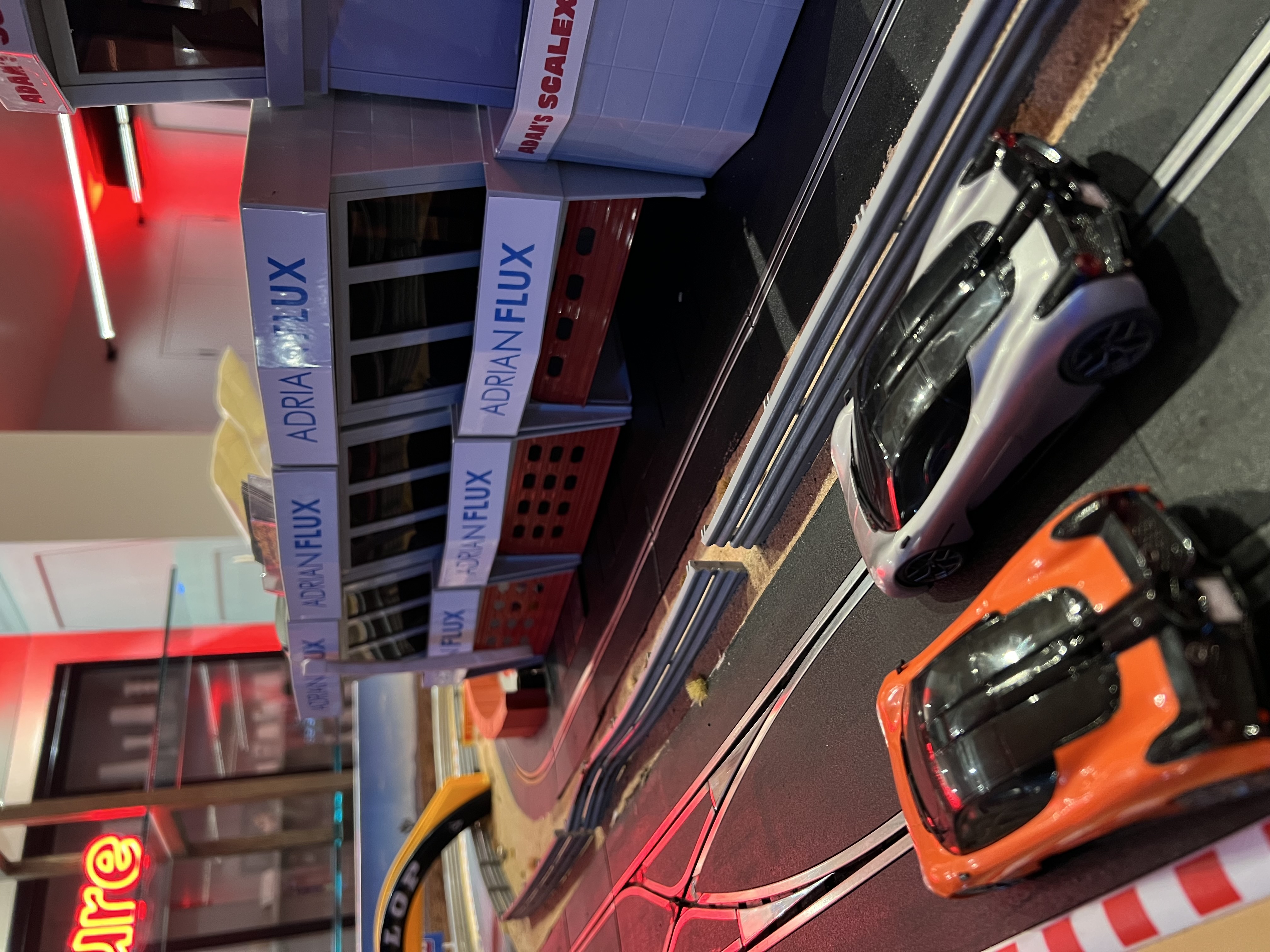 Live leaderboard and branded Scalextric setup at the Adrian Flux influencer party