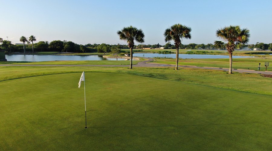 Oso Beach Golf Course at golden hour with coastal vegetation and water views