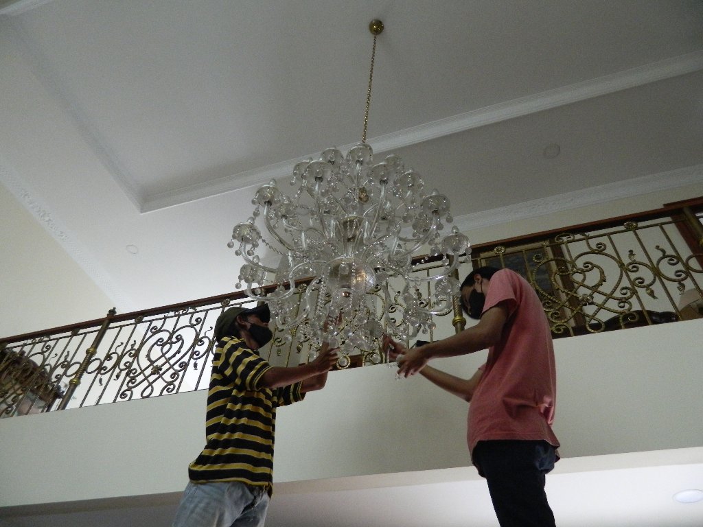 Proses pembersihan lampu kristal profesional oleh teknisi berpengalaman