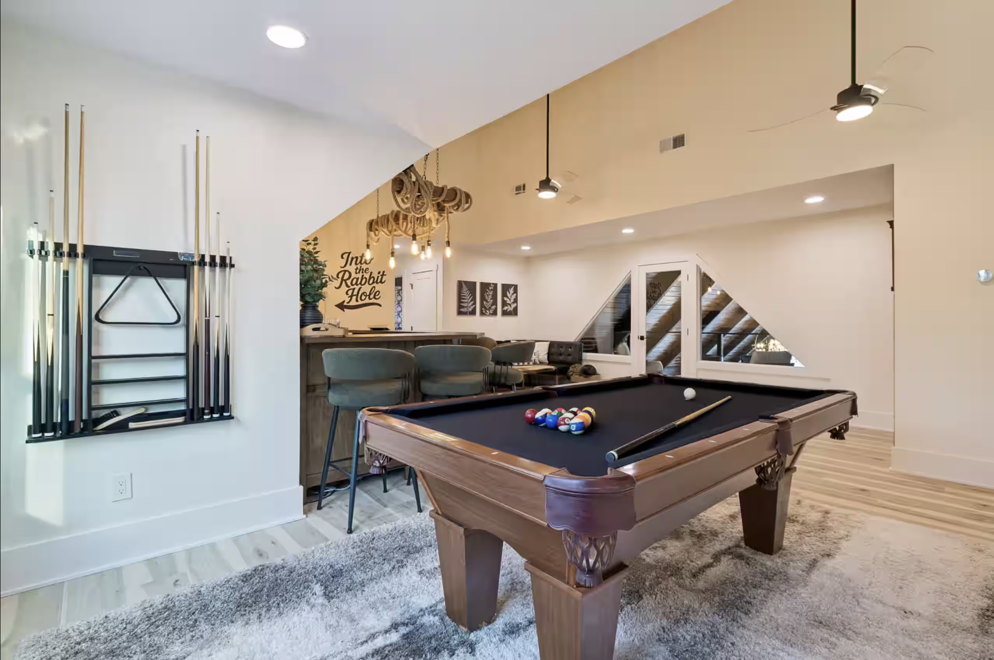 Game room with pool table and bar