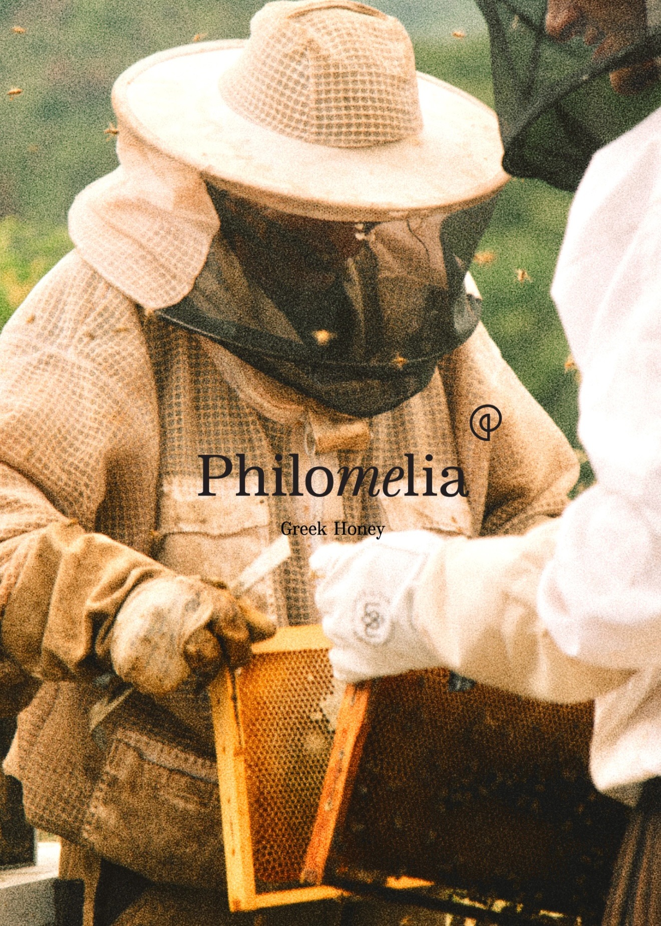 Philomelia Film — beekeepers working with a honey frame