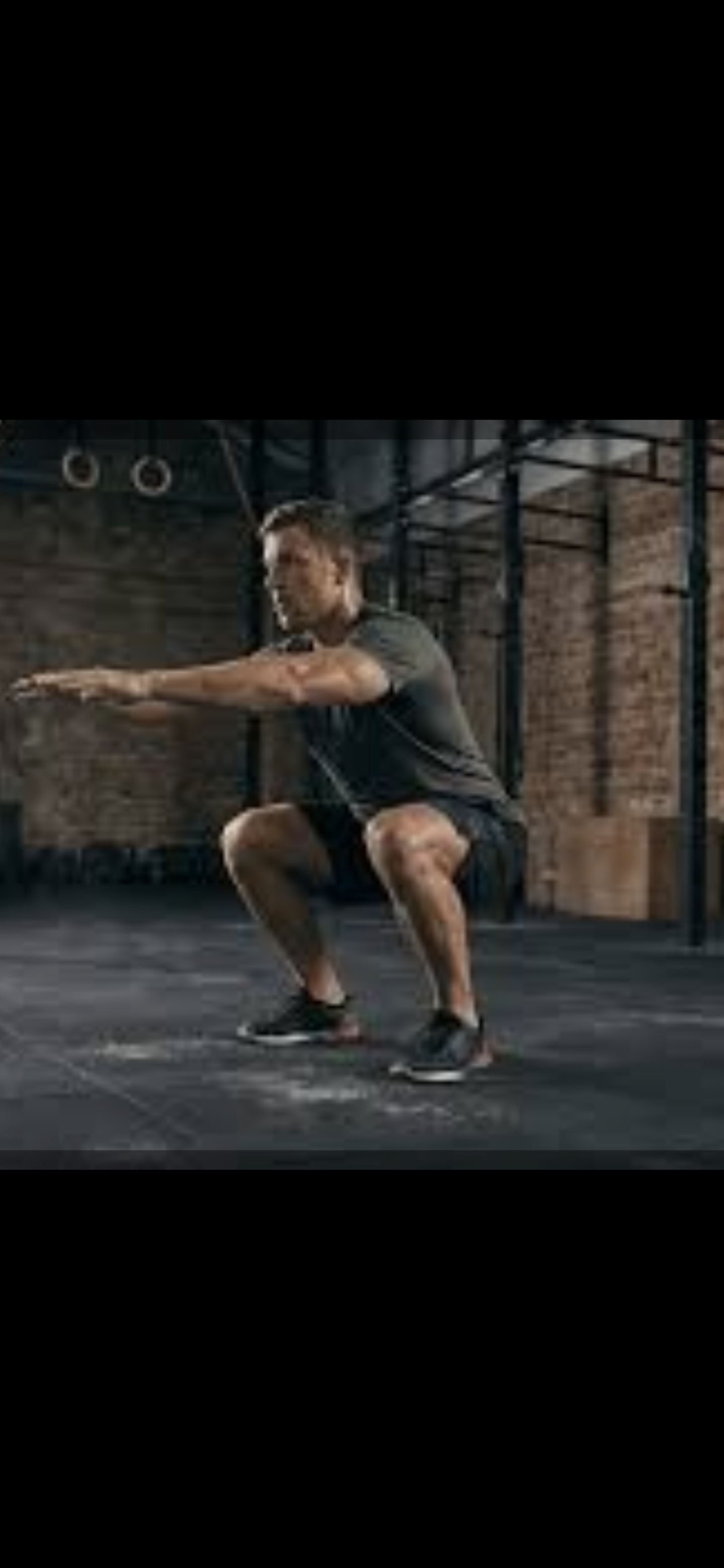 Man performing a squat exercise in a gym