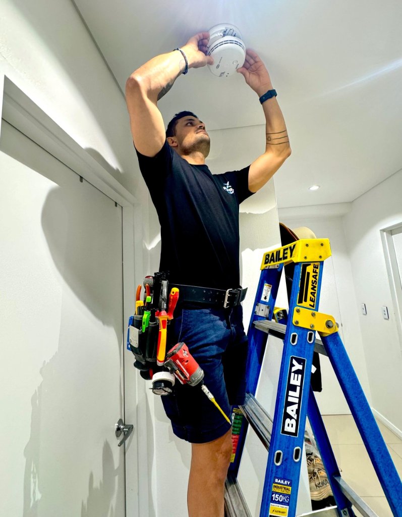 Licensed electrician installing smoke alarm Sydney