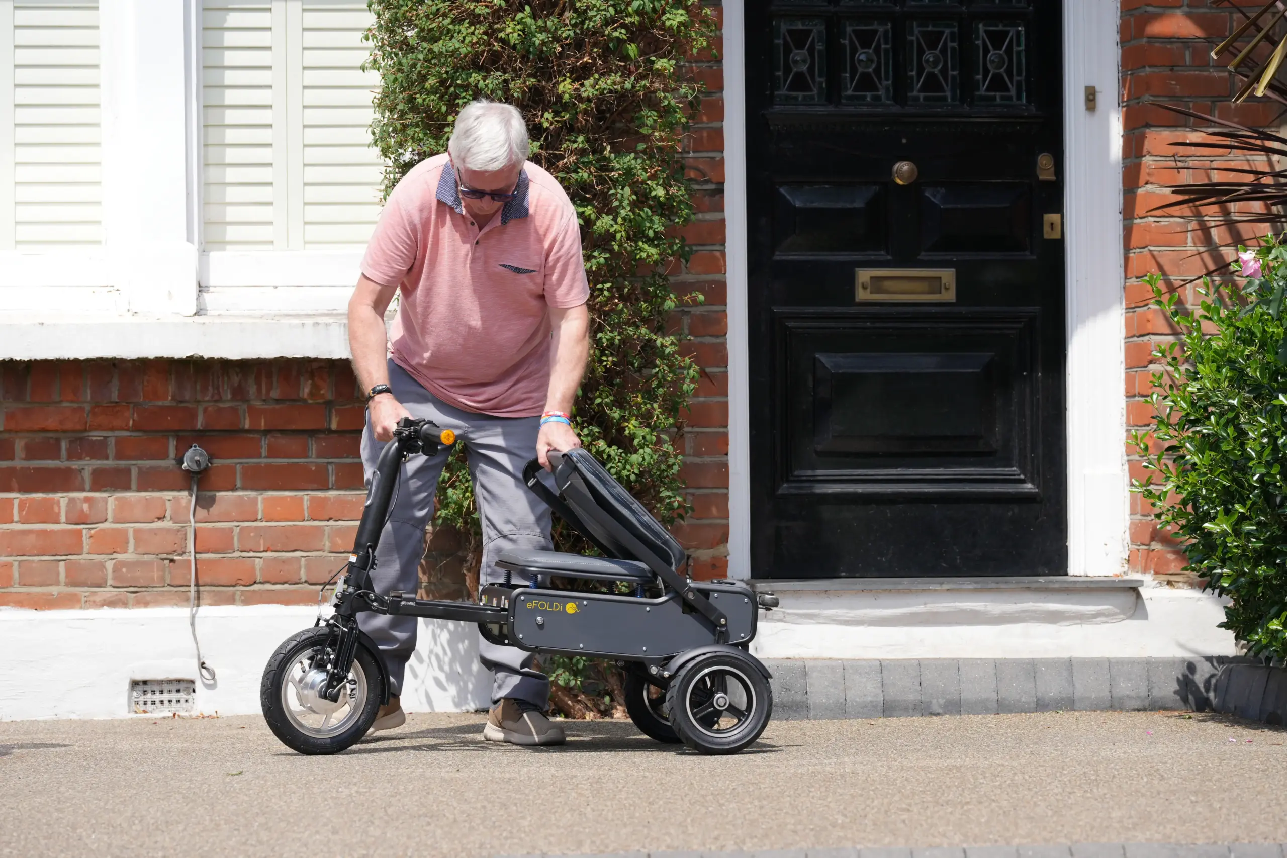 Man folding the eFOLDi outside front door
