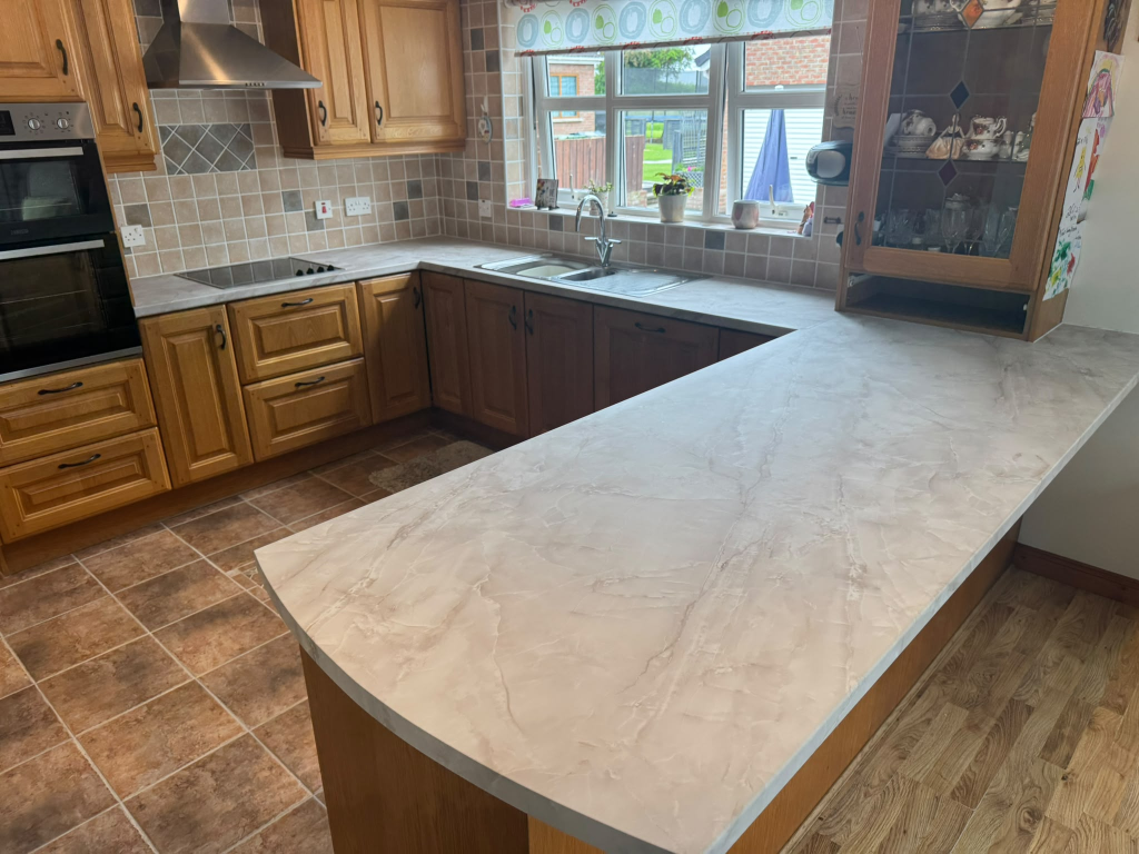 Same Northern Ireland kitchen transformed with light marble-effect vinyl wrap