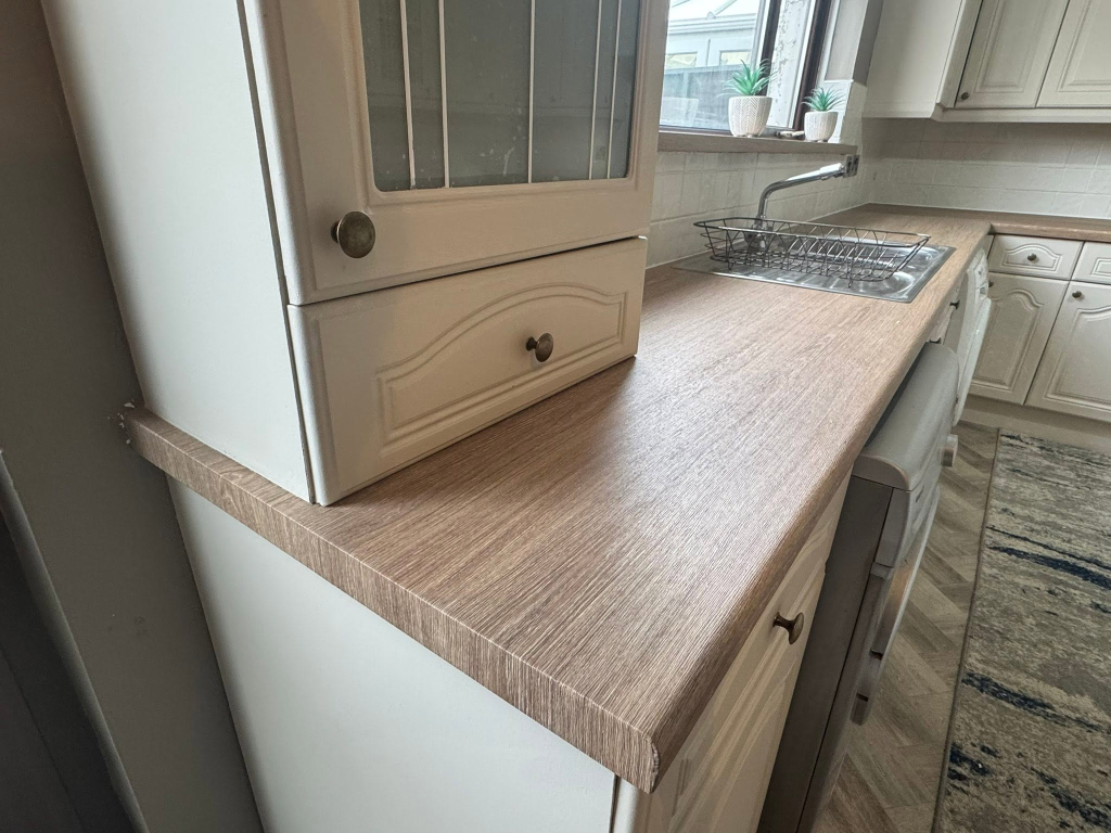 Close-up of dark oak wood-grain vinyl worktop edge