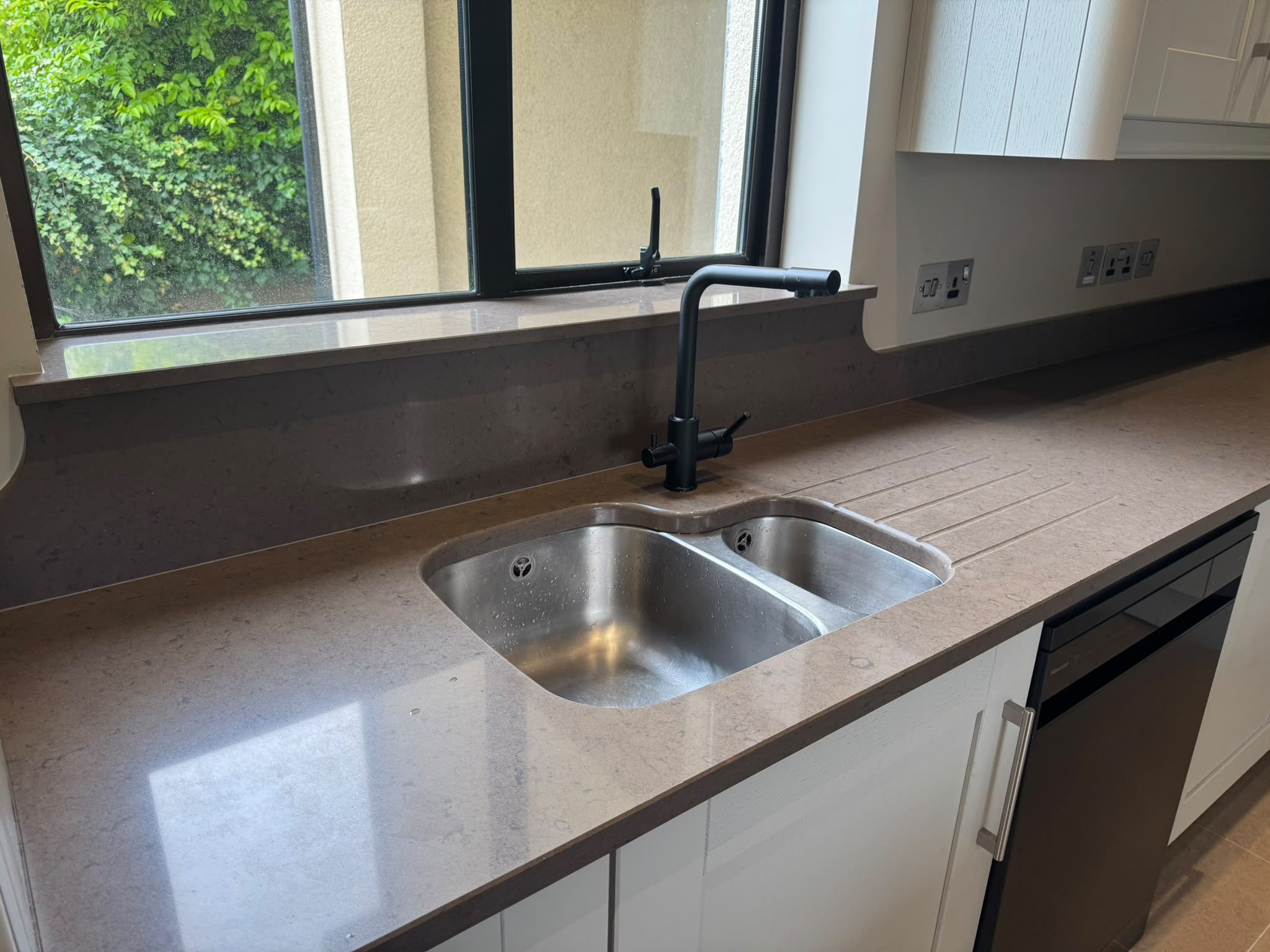 Grey stone-effect worktop with white cabinets before wrap