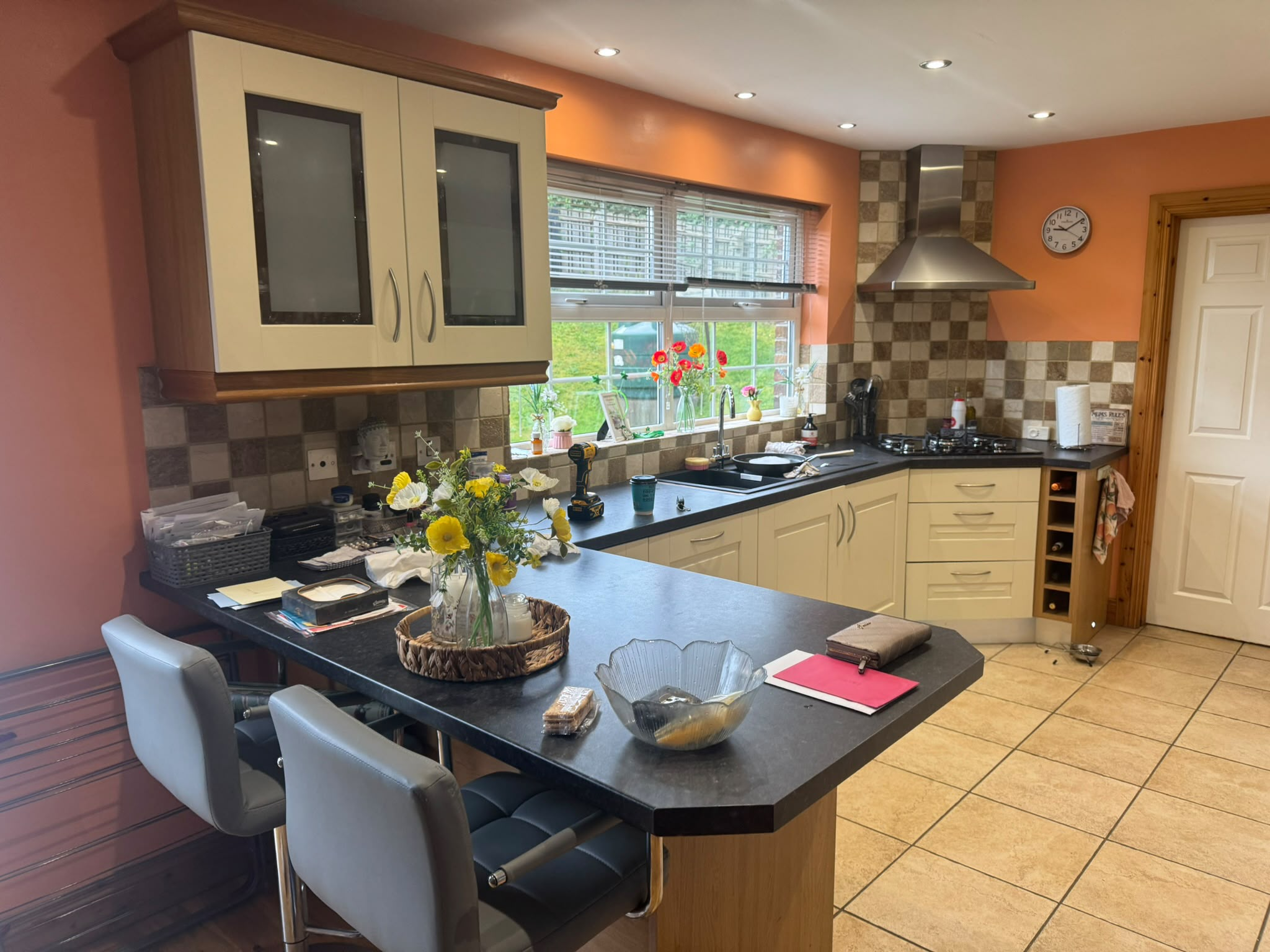 Cream kitchen with checkerboard tiles and peach walls before wrap
