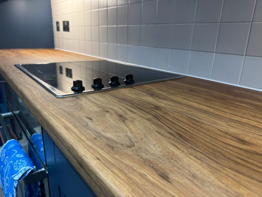 Overhead view of freshly wrapped kitchen island in light oak vinyl