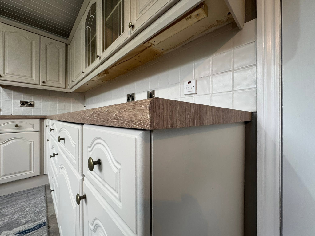 Angled view of worktop corner with antique bronze cabinet knob