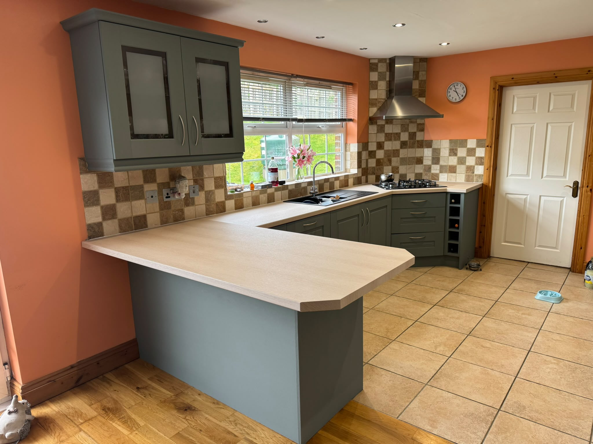 Same kitchen transformed with grey cabinetry and light oak worktop wrap