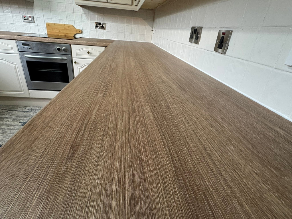 Detail shot of dark oak wood-grain vinyl wrap surface texture