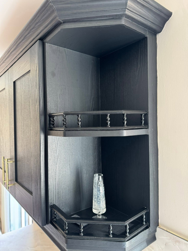 Corner shelving unit with decorative spindle railing in black wood wrap