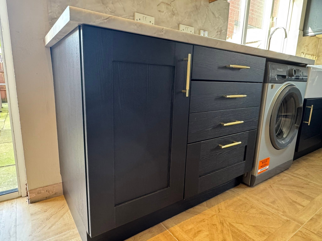 Base cabinet unit with black wood wrap, gold handles, and marble worktop
