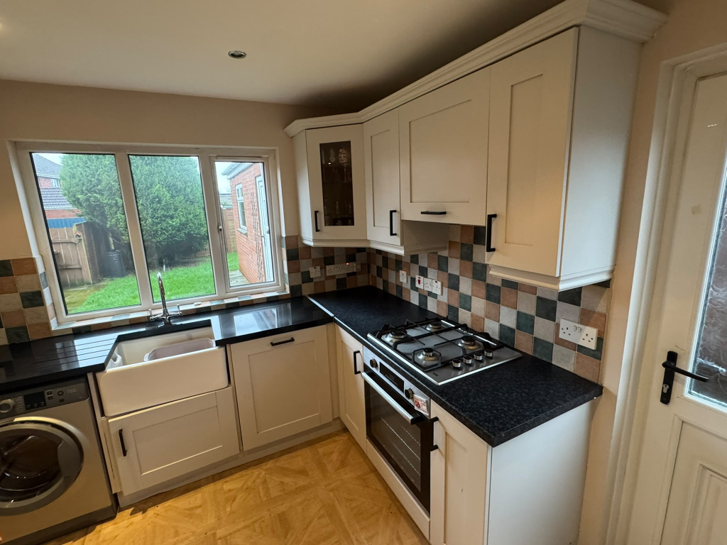 Dated cream kitchen cabinets in Newry before vinyl wrap