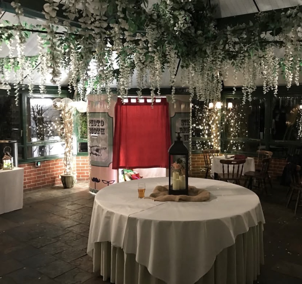 LD Photobooths photobooth hire at a wedding venue in Hampshire with floral decorations and fairy lights