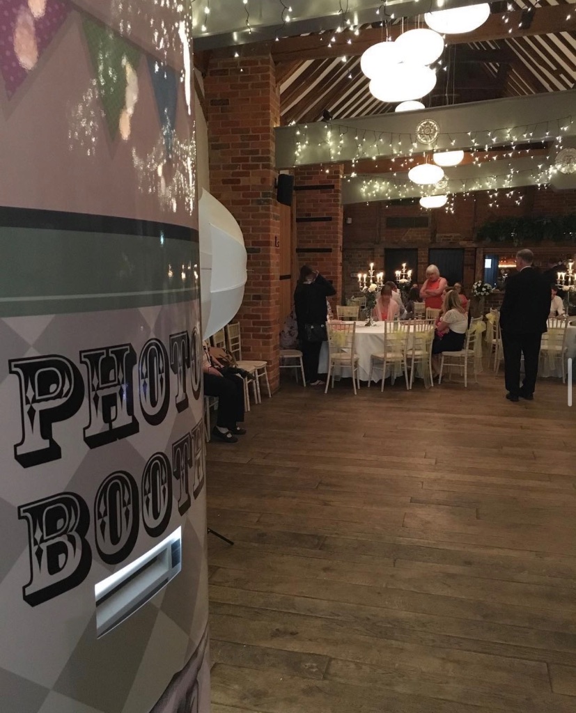 Photo booth hire at a barn wedding in Hampshire with fairy lights and guests