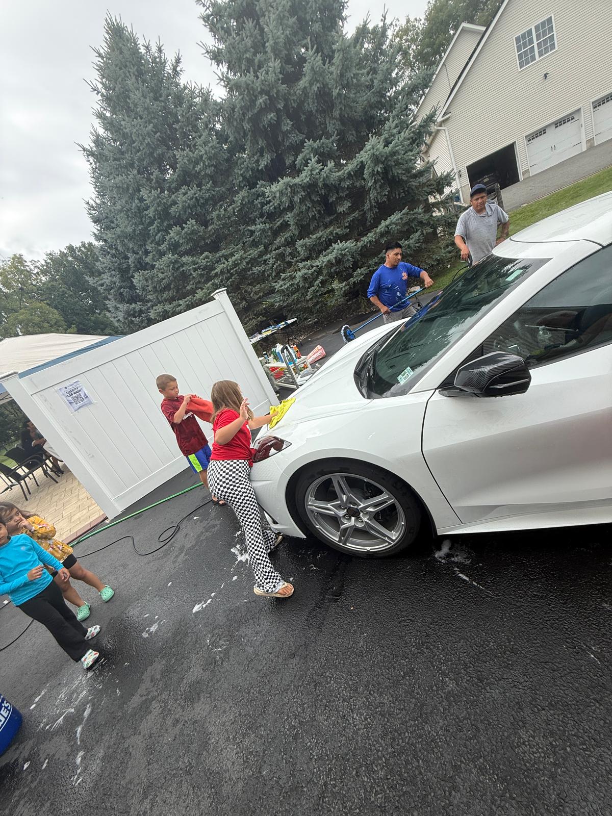 Kids drying the white SUV